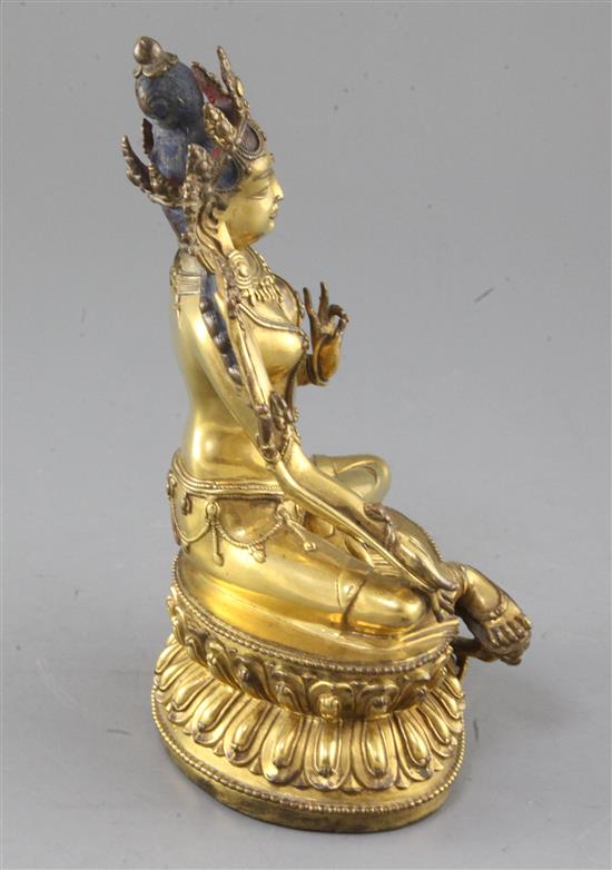A gilt Tibetan gilt bronze seated figure of Green Tara, 18th century, height 21.5cm